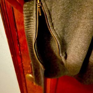 Grey cardigan. Zippers on both sides.